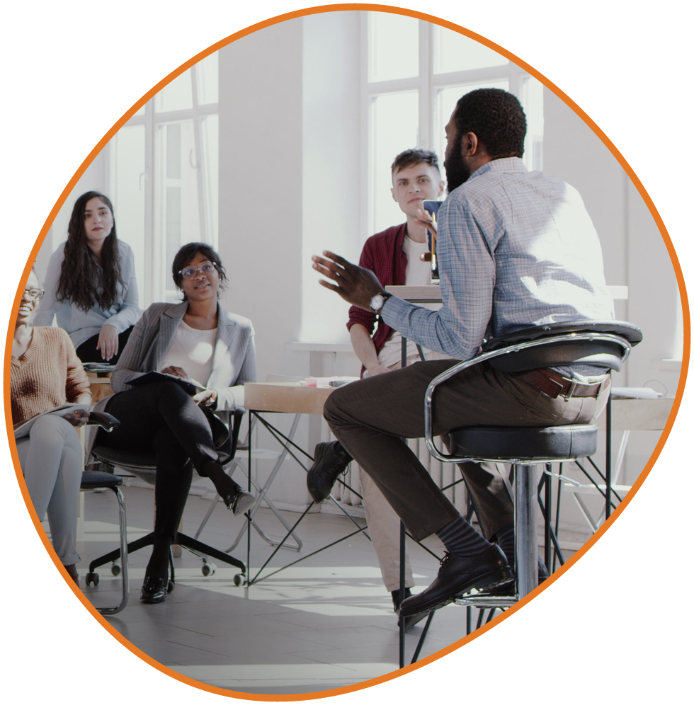 Leadership and innovation training session with professionals in a bright classroom Man giving speech is a large windowed room